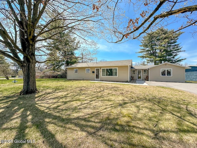 rear view of property featuring a lawn
