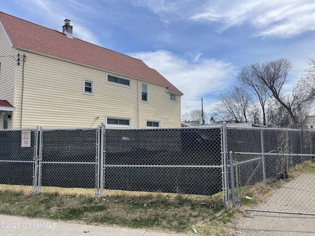 view of side of property featuring a gate and fence