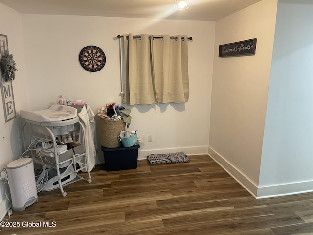 misc room featuring baseboards and wood finished floors