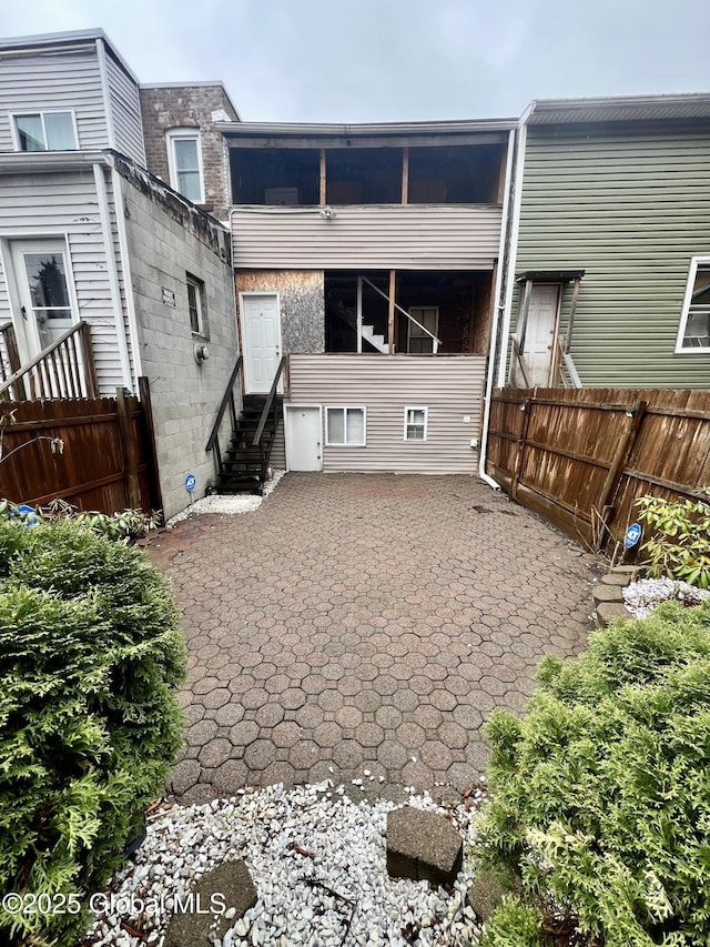 66 Jefferson St, Troy, NY 12180 - rear view of house featuring fence, entry steps, and a patio