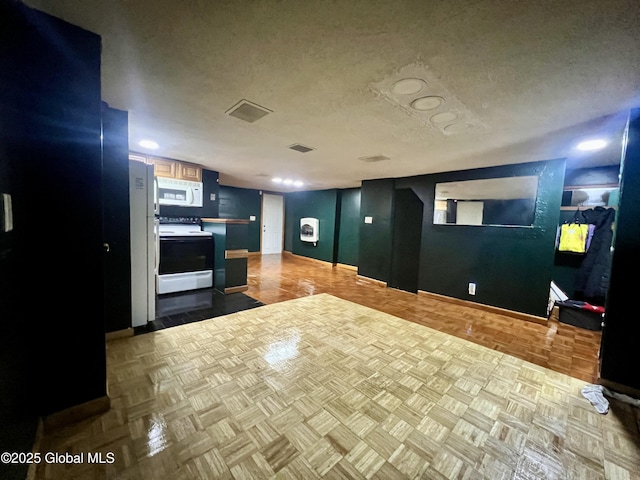 66 Jefferson St, Troy, NY 12180 - kitchen with white appliances, open floor plan, a textured ceiling, and baseboards