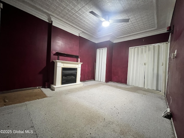 66 Jefferson St, Troy, NY 12180 - unfurnished living room featuring a ceiling fan, crown molding, carpet, a fireplace with raised hearth, and an ornate ceiling