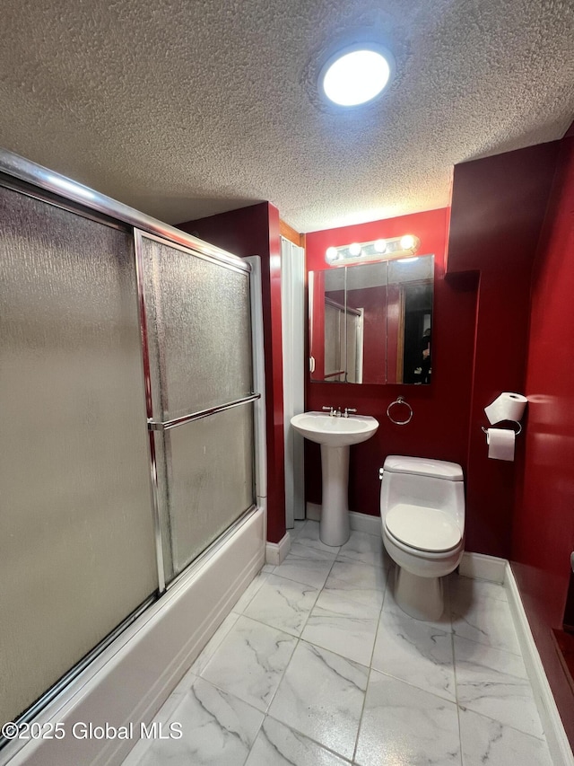 66 Jefferson St, Troy, NY 12180 - full bath featuring marble look tiles, toilet, baseboards, a textured ceiling, and bath / shower combo with glass door