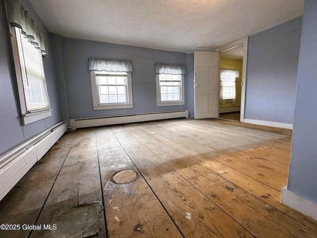230 S Rd, Stephentown, NY 12018 - spare room with a baseboard radiator, hardwood / wood-style flooring, and baseboards