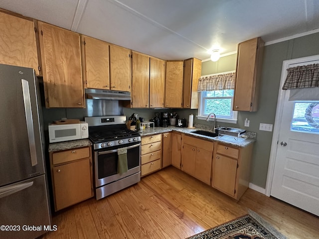 6325 Sunset Bay Rd, Dresden, NY 12841 - kitchen with a sink, stainless steel appliances, light wood finished floors, baseboards, and under cabinet range hood