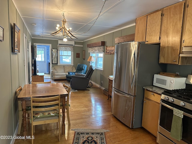 6325 Sunset Bay Rd, Dresden, NY 12841 - kitchen featuring light wood finished floors, stainless steel appliances, open floor plan, a chandelier, and under cabinet range hood