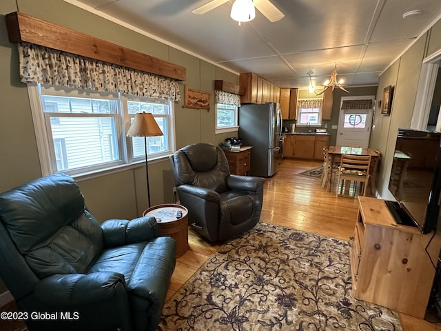 6325 Sunset Bay Rd, Dresden, NY 12841 - living room with light wood-type flooring and ceiling fan with notable chandelier