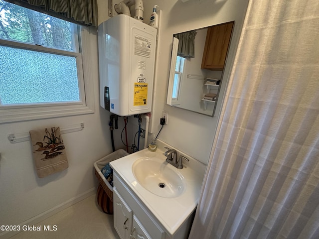6325 Sunset Bay Rd, Dresden, NY 12841 - bathroom with baseboards, vanity, and tankless water heater
