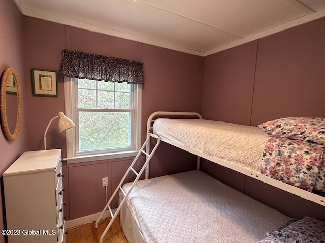 6325 Sunset Bay Rd, Dresden, NY 12841 - bedroom featuring light wood-style floors and a decorative wall