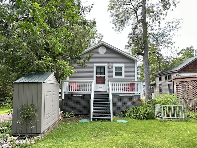 6325 Sunset Bay Rd, Dresden, NY 12841 - rear view of house featuring a shed, a wooden deck, a yard, and stairs