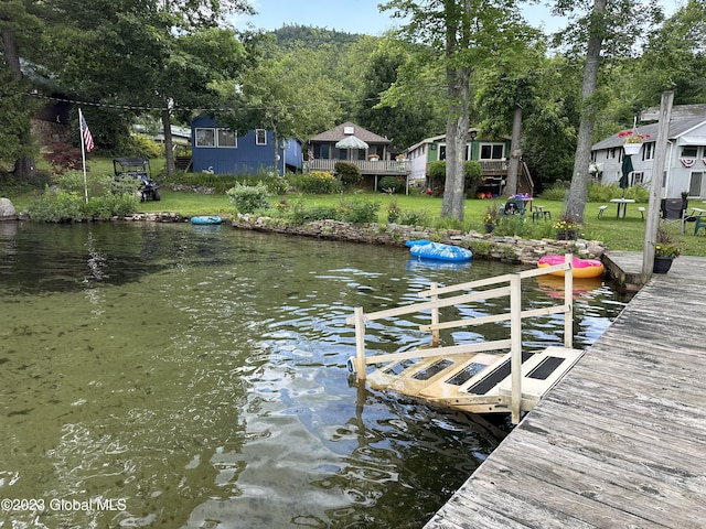 6325 Sunset Bay Rd, Dresden, NY 12841 - view of dock with a water view and a yard