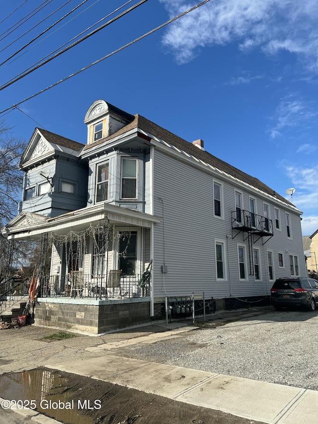 view of side of property with covered porch
