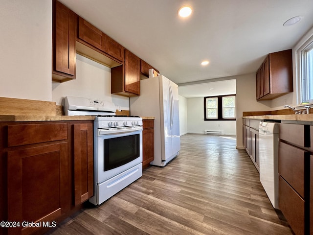 kitchen with a baseboard heating unit, white appliances, light countertops, dark wood finished floors, and recessed lighting