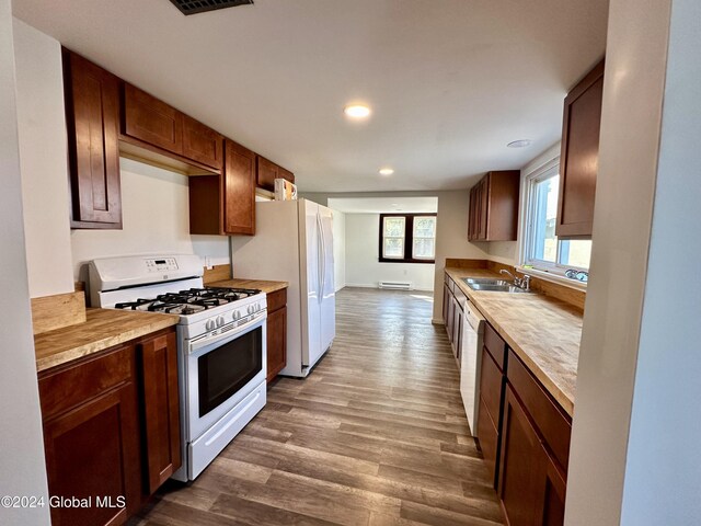 kitchen with recessed lighting, light countertops, dark wood-style flooring, and white appliances