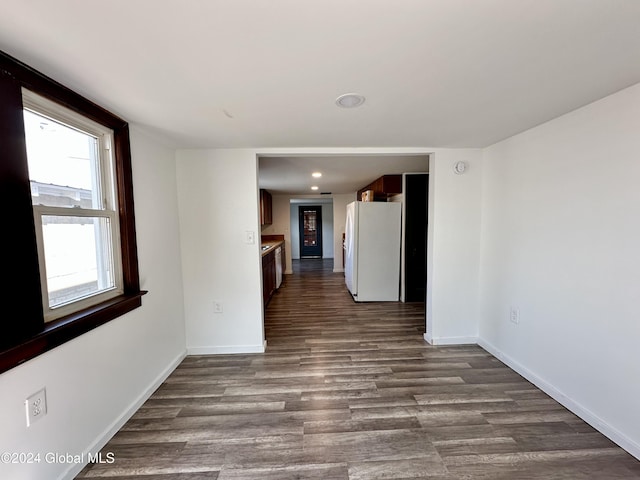 spare room with dark wood-type flooring, baseboards, and recessed lighting