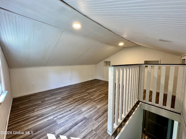 additional living space featuring vaulted ceiling, wood finished floors, and baseboards