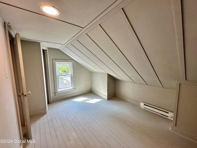 bonus room with hardwood / wood-style flooring, a baseboard radiator, lofted ceiling, and baseboards