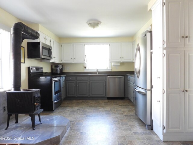 116 Dennie Rd, Mayfield, NY 12117 - kitchen featuring stainless steel appliances, dark countertops, gray cabinets, white cabinets, and a sink