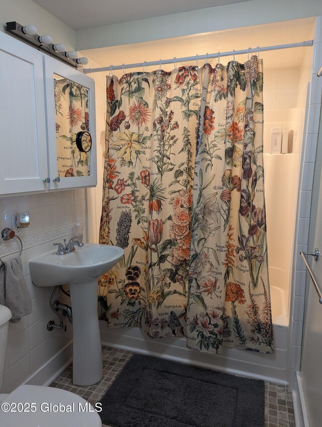 116 Dennie Rd, Mayfield, NY 12117 - bathroom featuring shower / bathtub combination with curtain, tasteful backsplash, and a sink
