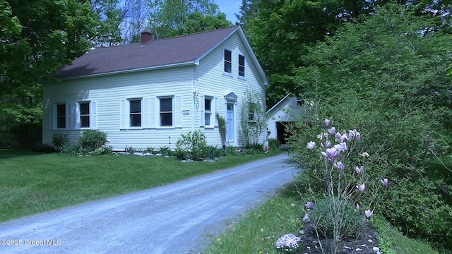 116 Dennie Rd, Mayfield, NY 12117 - view of front of property with a chimney, a front yard, an outdoor structure, and driveway