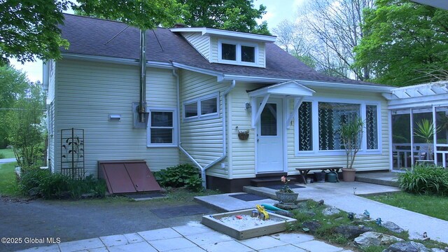 116 Dennie Rd, Mayfield, NY 12117 - back of house featuring entry steps, a shingled roof, and a patio area