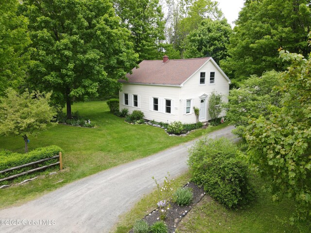 116 Dennie Rd, Mayfield, NY 12117 - view of front of home featuring a chimney, dirt driveway, and roof with shingles