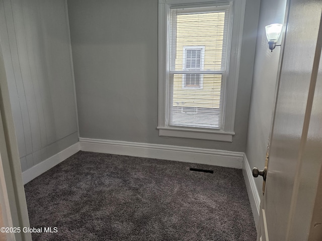 235 5th Ave, Troy, NY 12180 - unfurnished room with visible vents, dark colored carpet, and baseboards