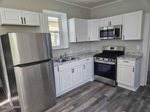 235 5th Ave, Troy, NY 12180 - kitchen featuring stainless steel appliances, white cabinetry, ornamental molding, a sink, and dark wood-style flooring