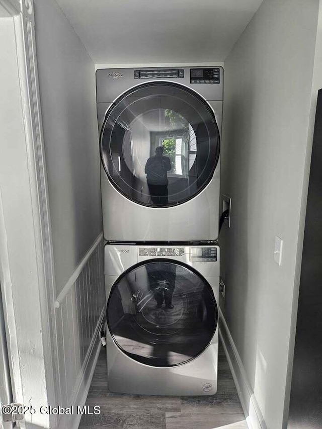 235 5th Ave, Troy, NY 12180 - laundry room featuring stacked washer / drying machine, wood finished floors, and laundry area