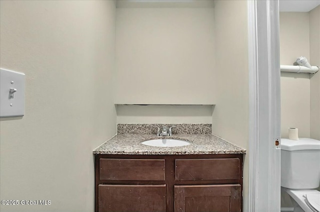 bathroom with toilet and vanity