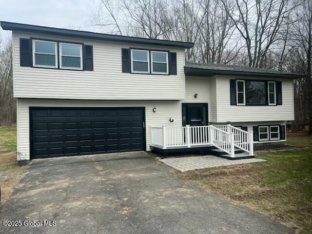 tri-level home featuring driveway and a garage