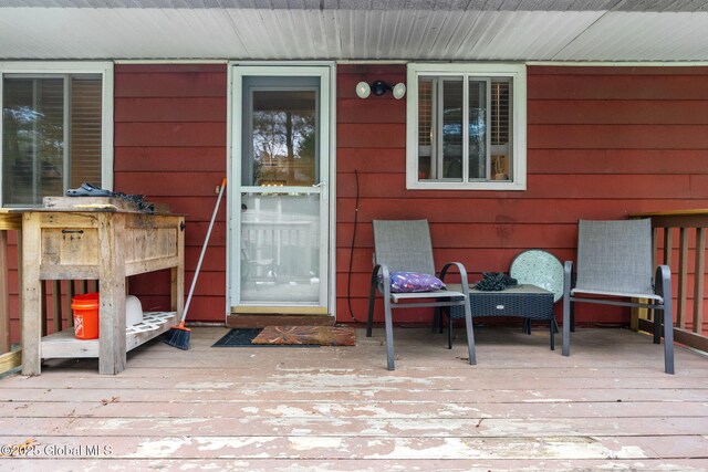 view of exterior entry featuring a deck