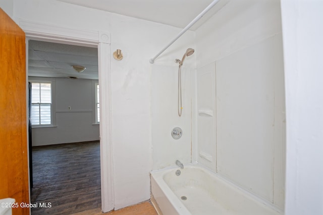 full bath featuring bathing tub / shower combination and wood finished floors
