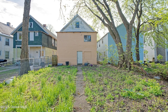back of house with fence