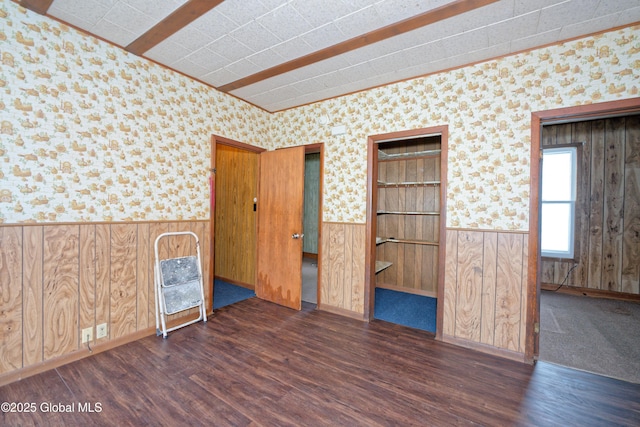 unfurnished room with wainscoting, wallpapered walls, and wood finished floors