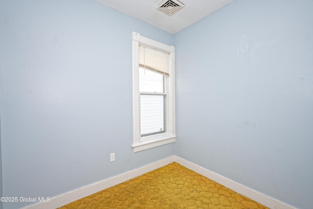 spare room with visible vents and baseboards