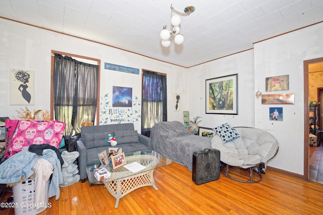 living area with wood-type flooring and a notable chandelier