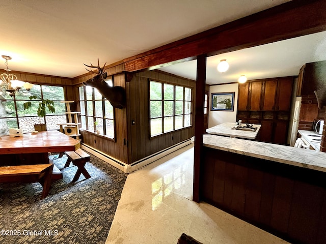 155 Bowen Hill Rd, Thurman, NY 12885 - kitchen with wooden walls, beam ceiling, a chandelier, decorative light fixtures, and a baseboard heating unit