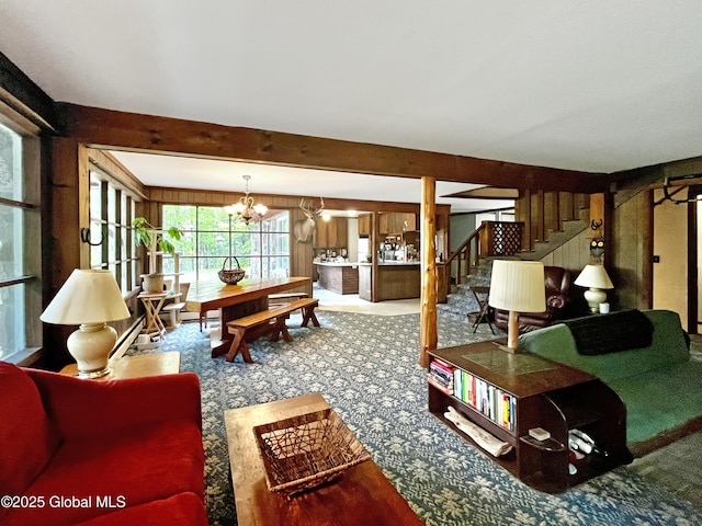 155 Bowen Hill Rd, Thurman, NY 12885 - carpeted living area featuring stairway, a chandelier, beam ceiling, and wooden walls