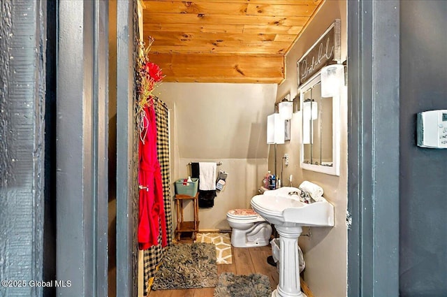 half bathroom featuring wood finished floors, toilet, and wood ceiling