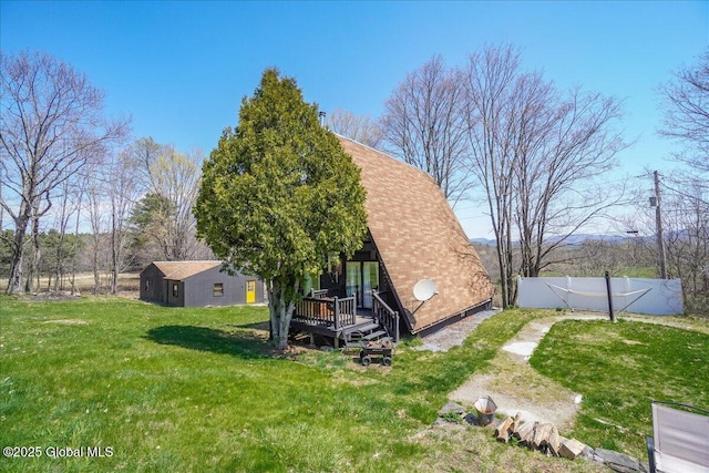 exterior space with a deck, fence, and a yard