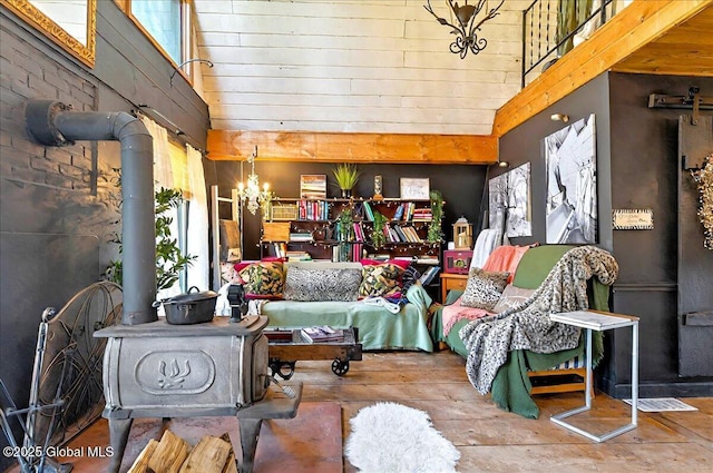 bedroom featuring a notable chandelier, a high ceiling, and wood-type flooring