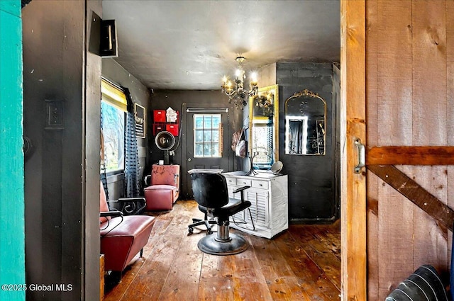 interior space with hardwood / wood-style flooring and an inviting chandelier