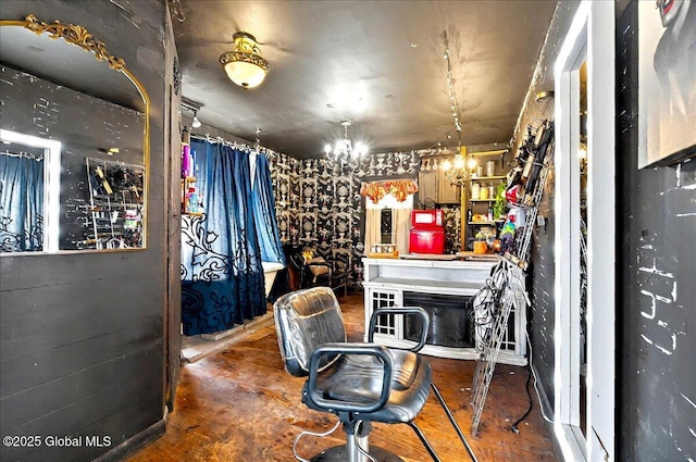 interior space with concrete floors and a notable chandelier