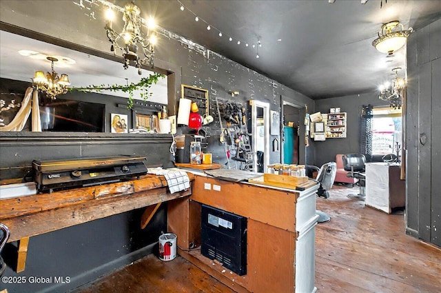 interior space featuring a chandelier and concrete flooring
