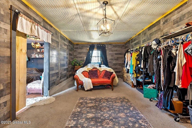 walk in closet featuring a chandelier