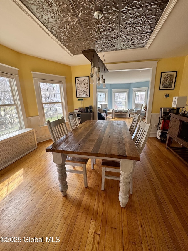 47 Washington Rd, Scotia, NY 12302 - dining room featuring hardwood / wood-style floors, wainscoting, radiator, and an ornate ceiling