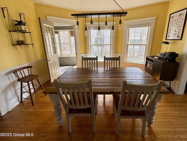 47 Washington Rd, Scotia, NY 12302 - dining room with a healthy amount of sunlight, hardwood / wood-style flooring, and wainscoting