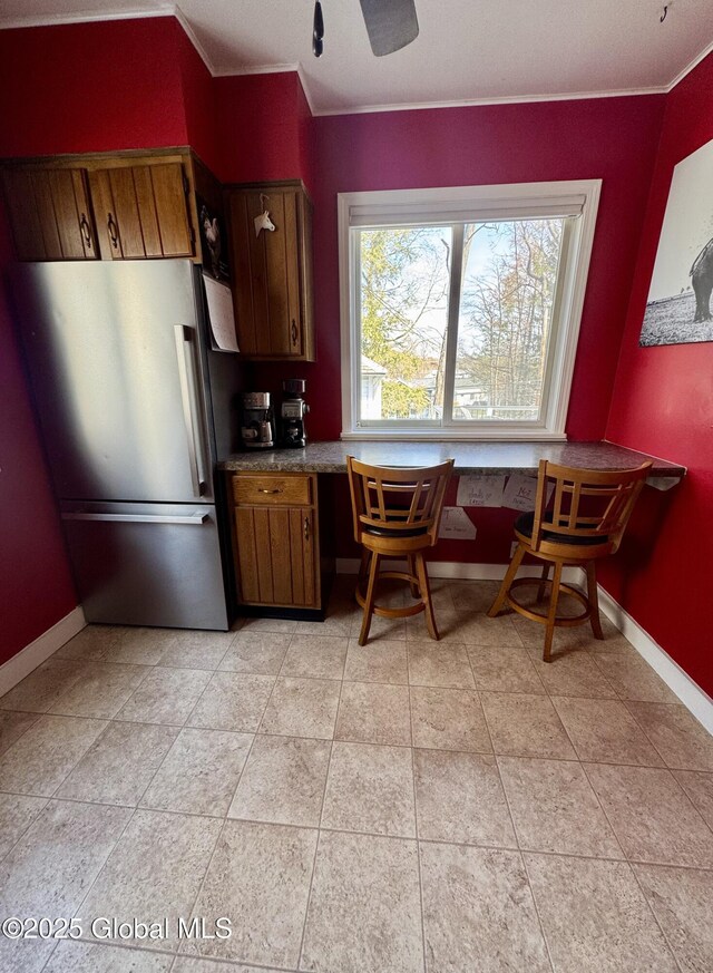 47 Washington Rd, Scotia, NY 12302 - kitchen featuring baseboards, freestanding refrigerator, built in desk, and crown molding