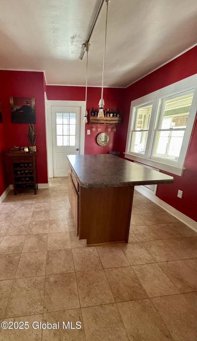 47 Washington Rd, Scotia, NY 12302 - kitchen with light tile patterned floors, baseboards, dark countertops, and a kitchen island